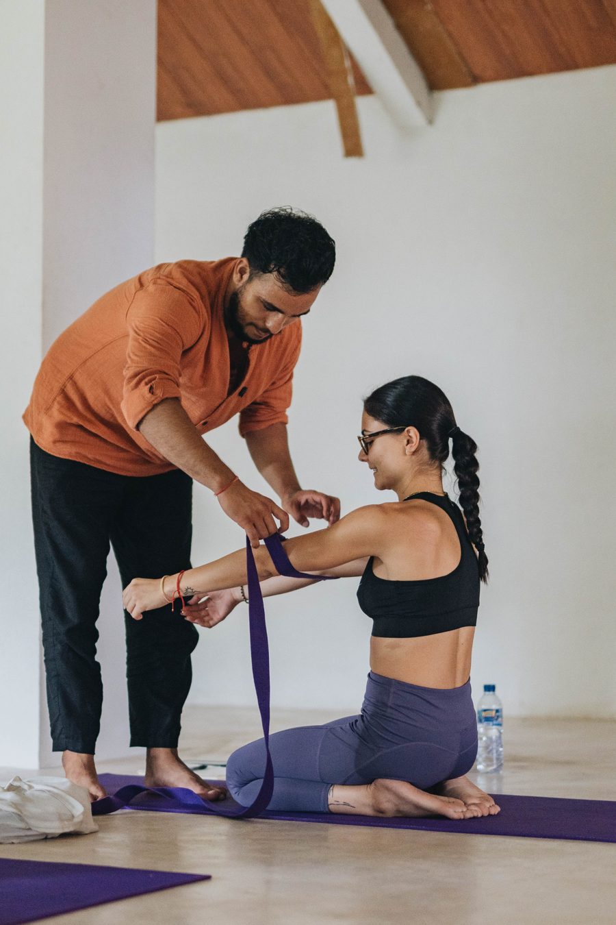 Hands-on shoulder adjustment during class