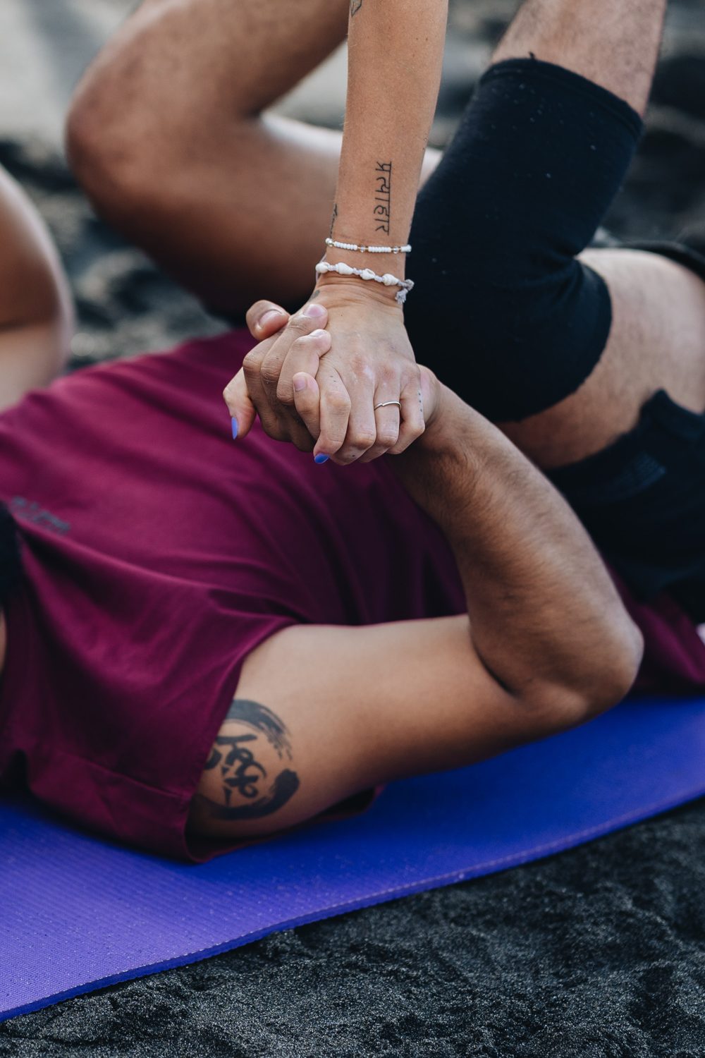 Acro Yoga hand-clasp between base and flyer